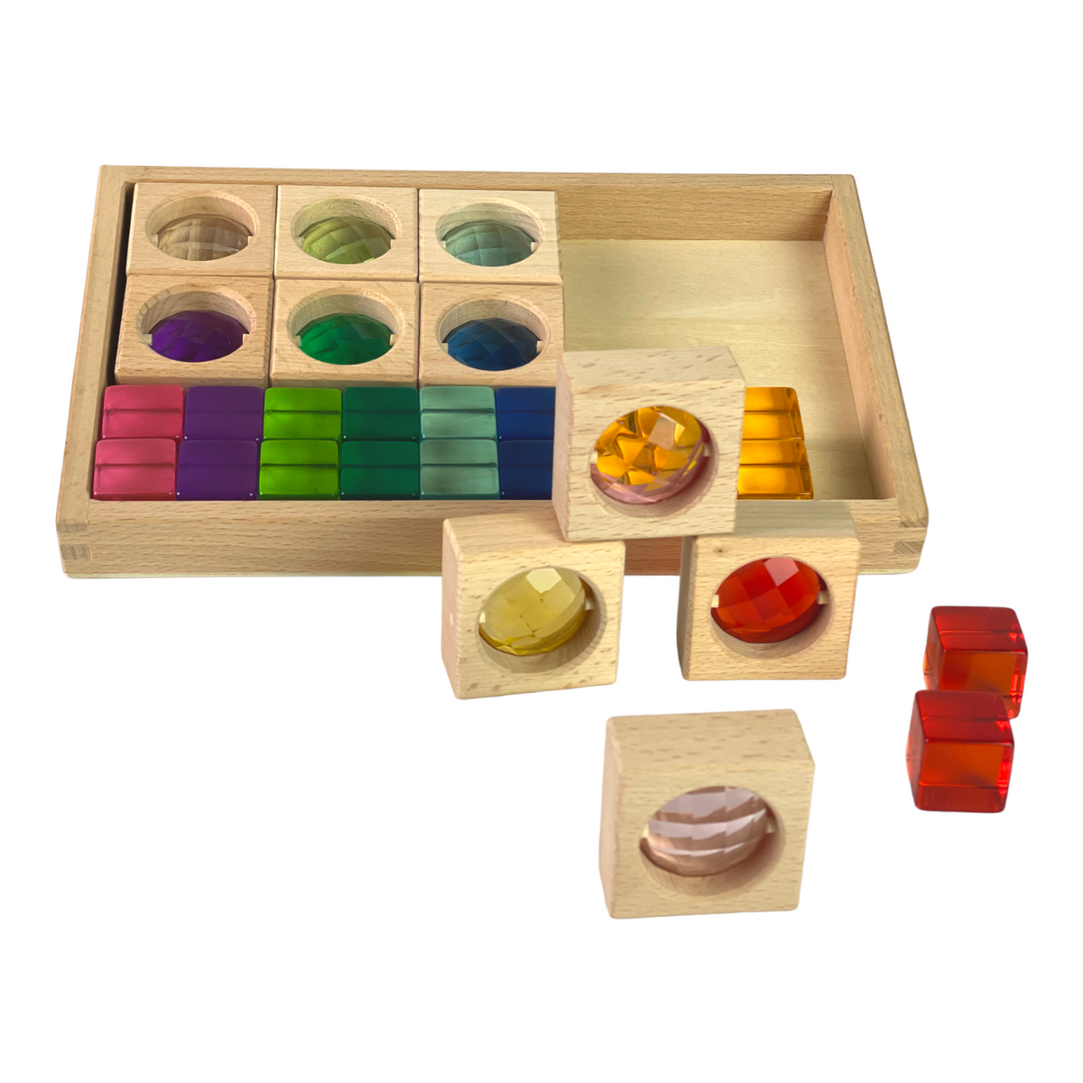 Gem blocks and lucite cubes partly unpacked from the beechwood storage tray