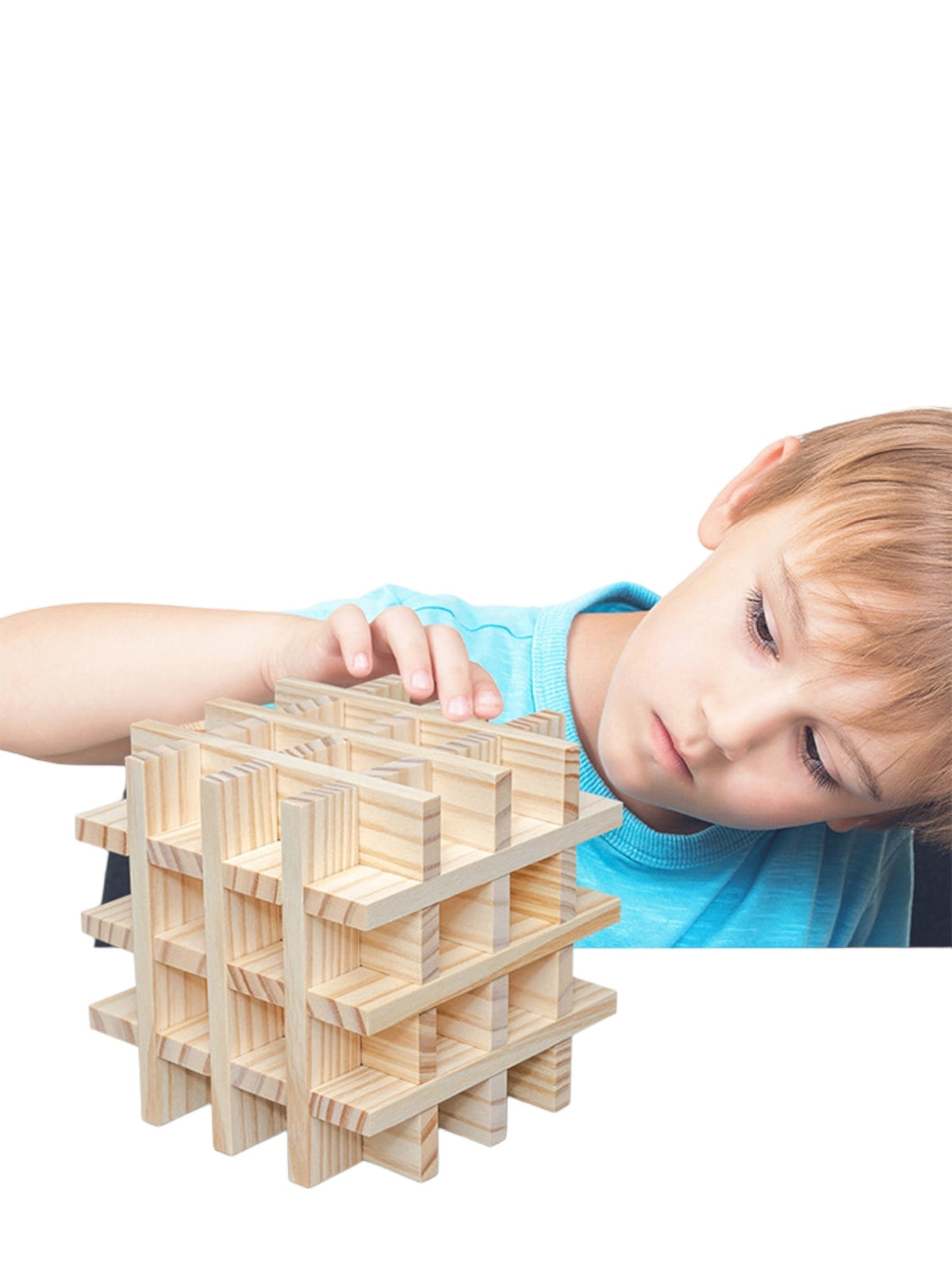 Child adding a plank to a wooden cube structure
