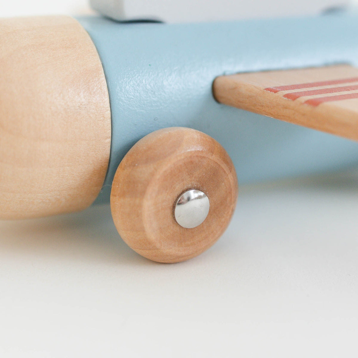 SpiritnSprout: Close-up of the blue airplane’s wooden wheel and wing
