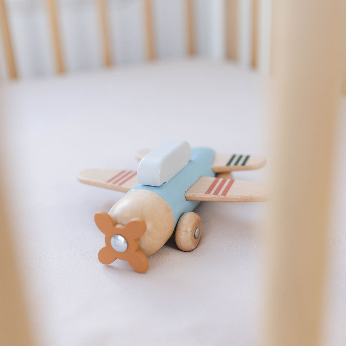 SpiritnSprout: Blue wooden airplane on a small white table