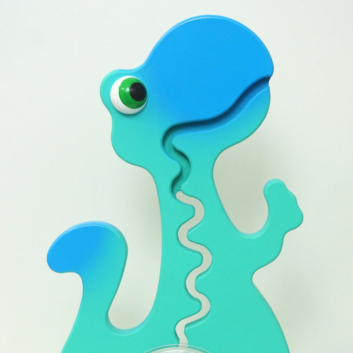 Close-up of the aqua and blue dinosaur head and front coin track