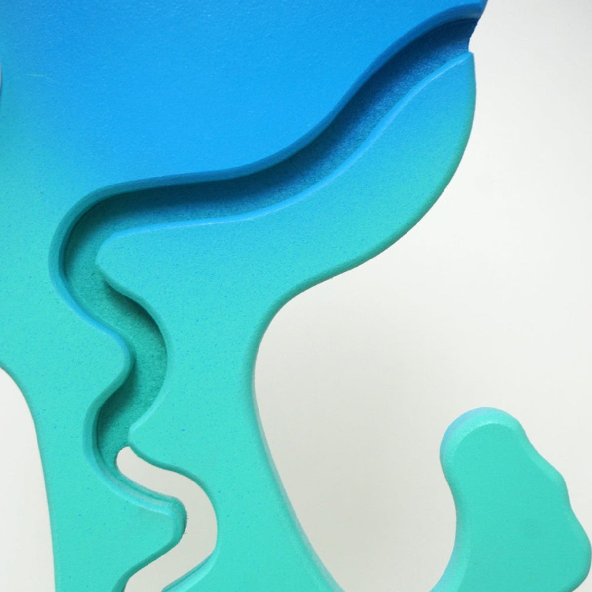 Close-up of the aqua dinosaur carved zigzag coin track