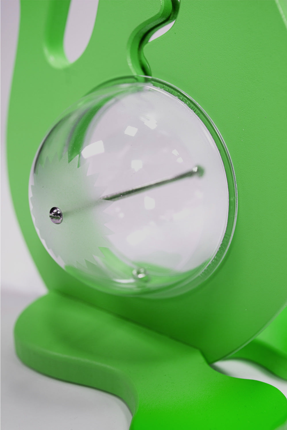 Close-up of the green dinosaur bank clear belly, metal bolt and base