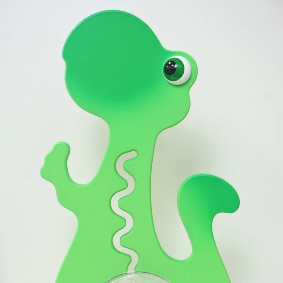 Reverse-side close-up of the green dinosaur head and upper body