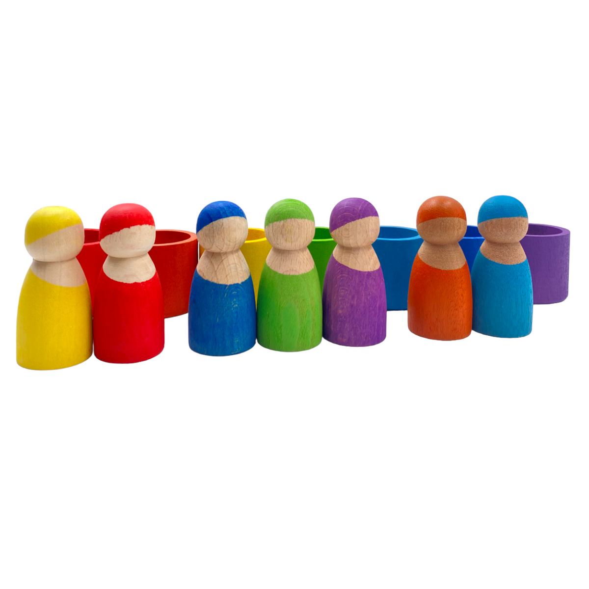 Seven rainbow wooden peg dolls lined up with matching bowls behind them