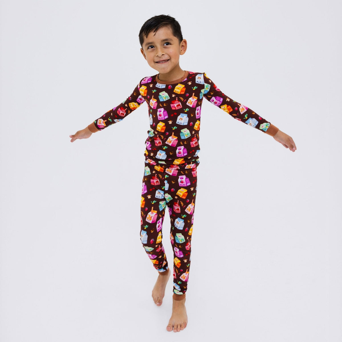 Child standing with arms outstretched in Bam & Stitch All the Milks! Long Sleeve Pajamas.