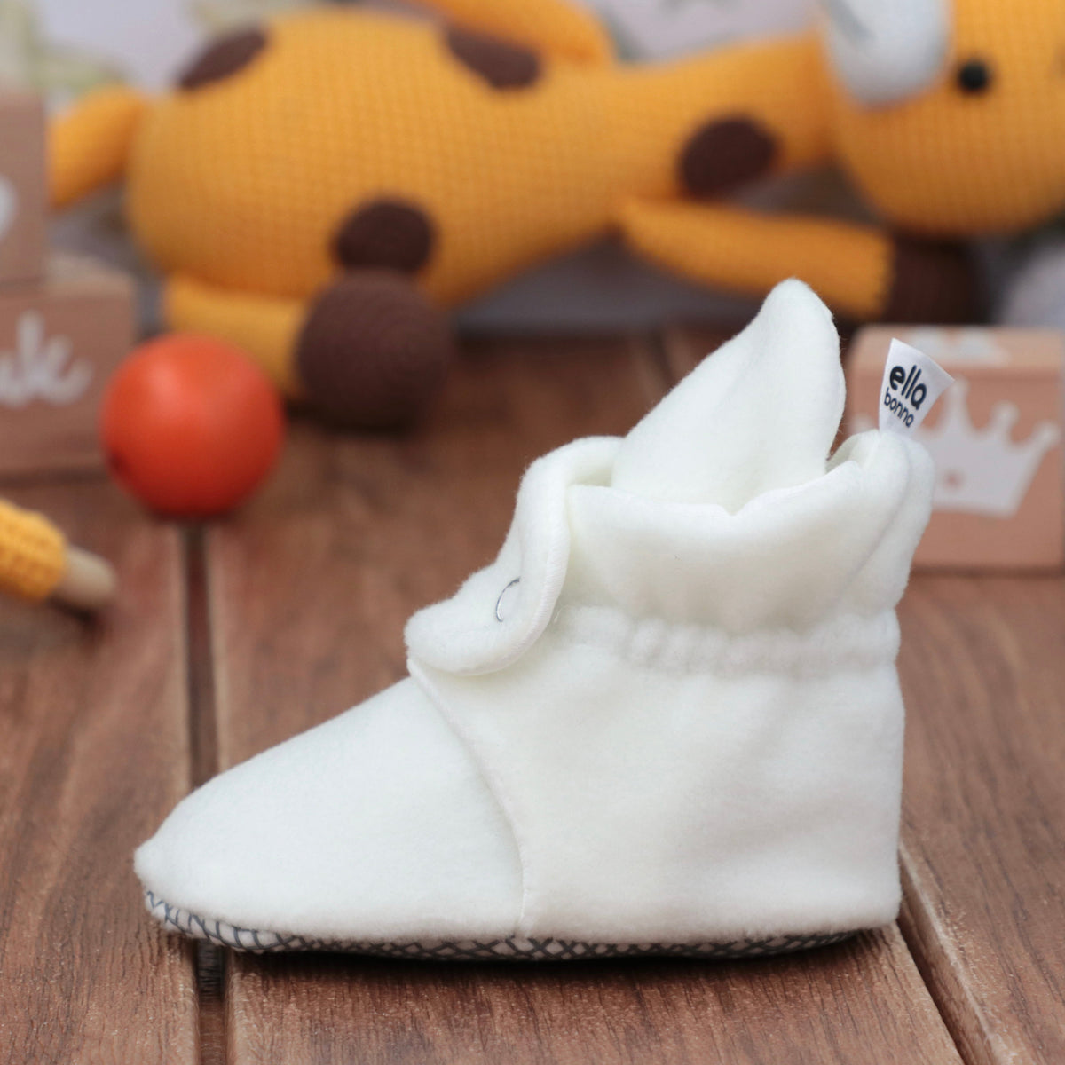 Single bootie on a tabletop, side view.