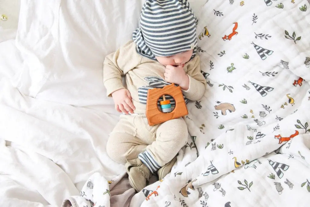 Lifestyle photo showing a wooden state rattle with a child