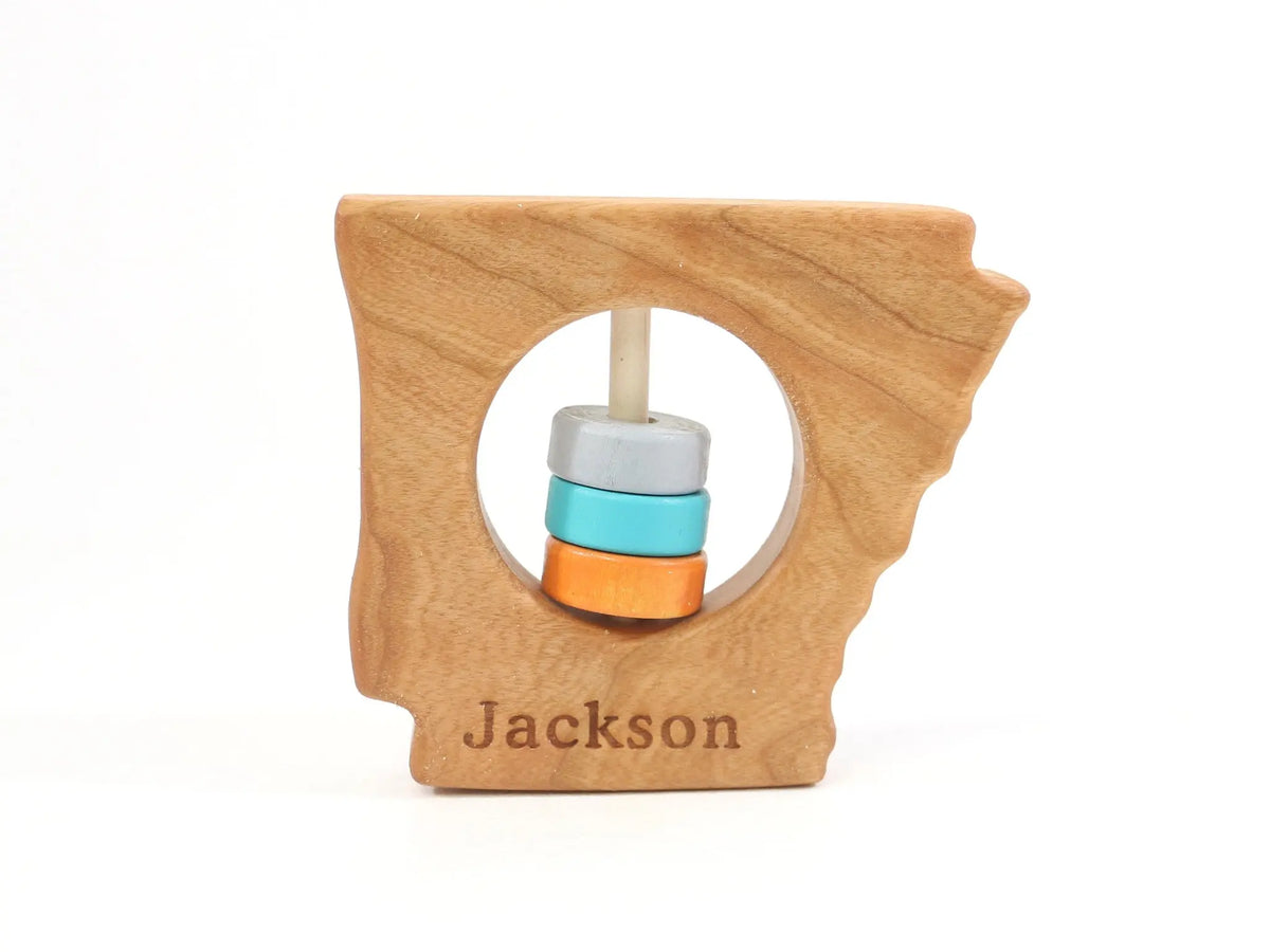 Bannor Toys Arkansas State Wooden Baby Rattle with example laser engraving and colored rattle discs
