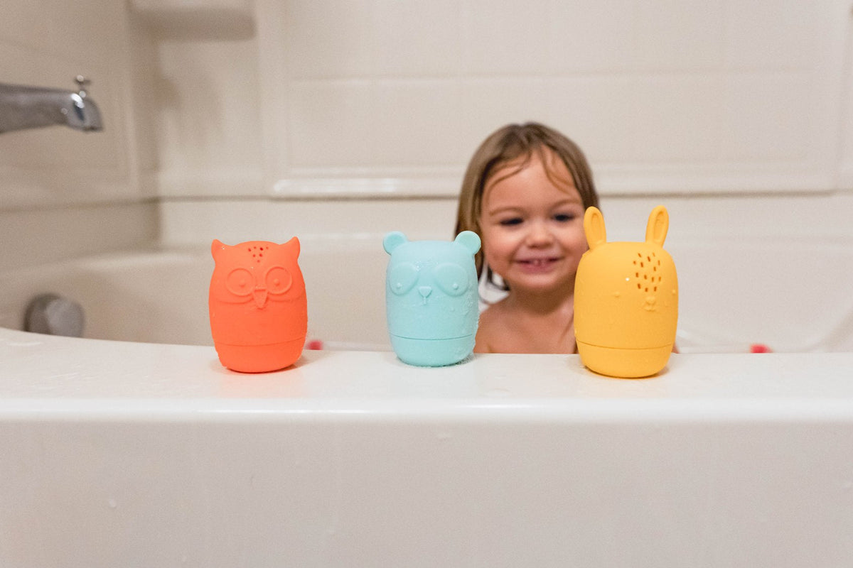 Lifestyle photo showing silicone bath toys with a child