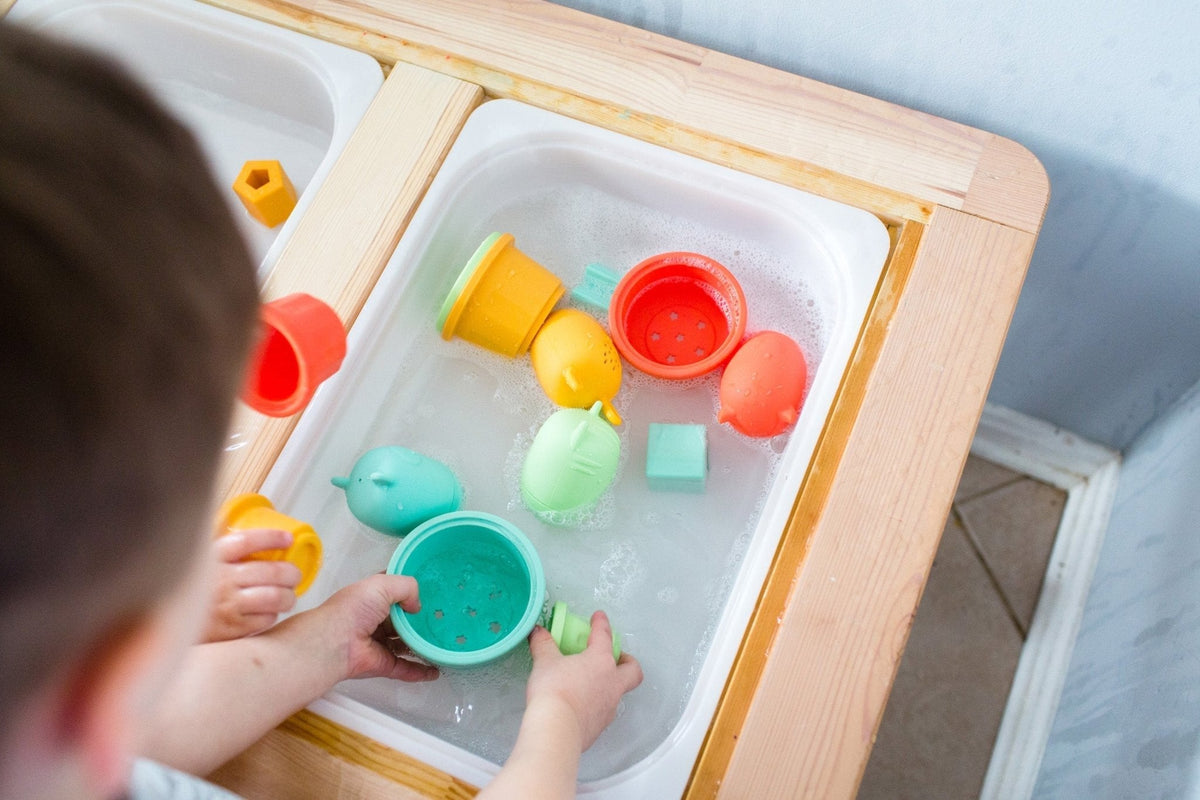 Lifestyle photo showing silicone bath toys with a child