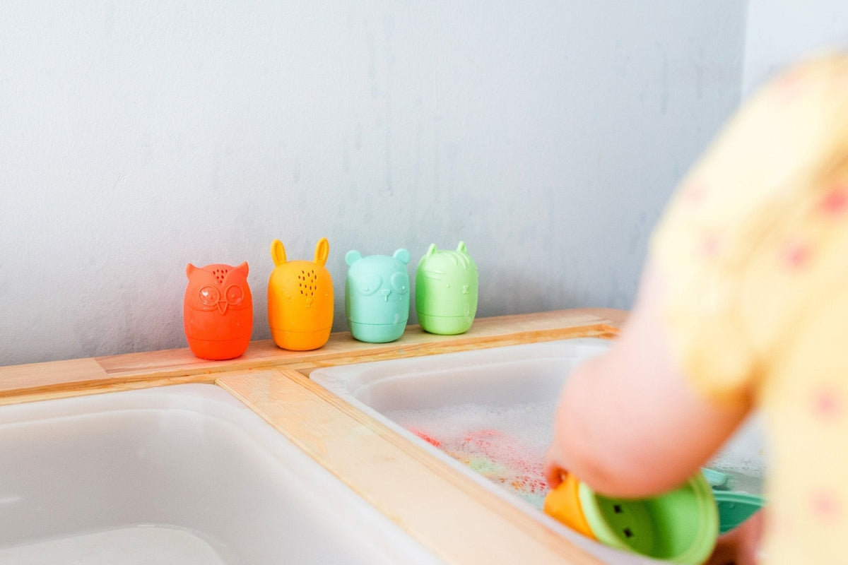 Lifestyle photo showing silicone bath toys with a child