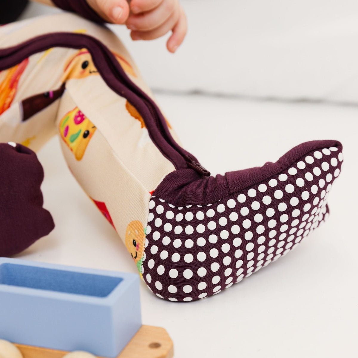 Close-up of the fold-over feet and dotted soles on Bam & Stitch Blissful Bites Convertible Romper.