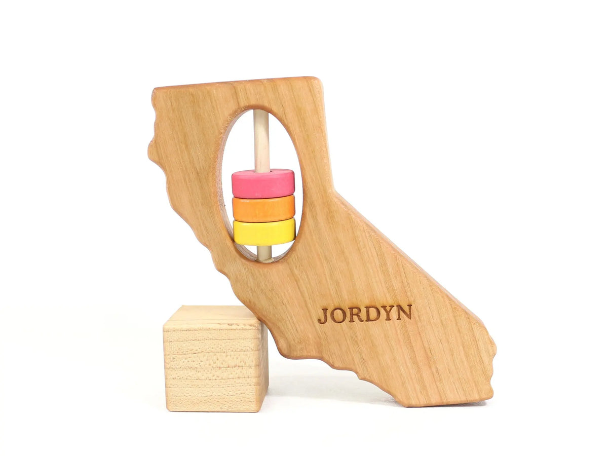 Bannor Toys California State Wooden Baby Rattle with example laser engraving and colored rattle discs