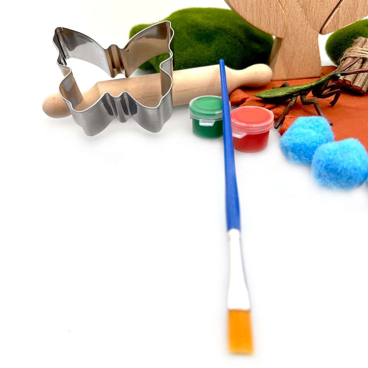 Butterfly cutter, rolling pin, paintbrush and paint pots in the Camping Trip set