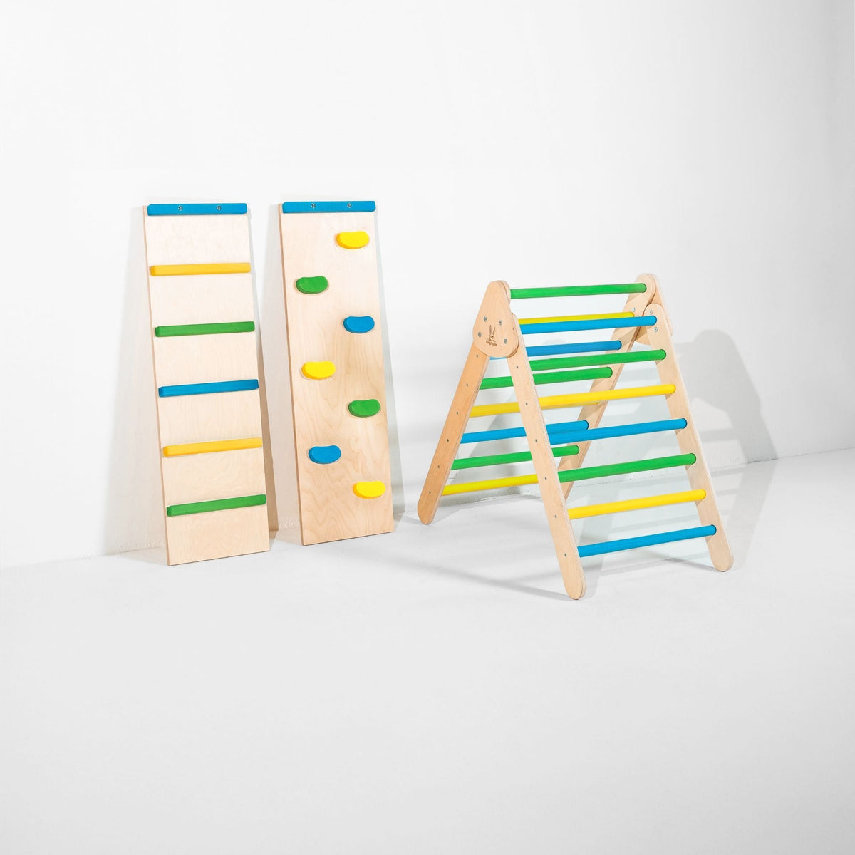 Classic Climber triangle with blue, green and yellow rungs beside two upright ramps.
