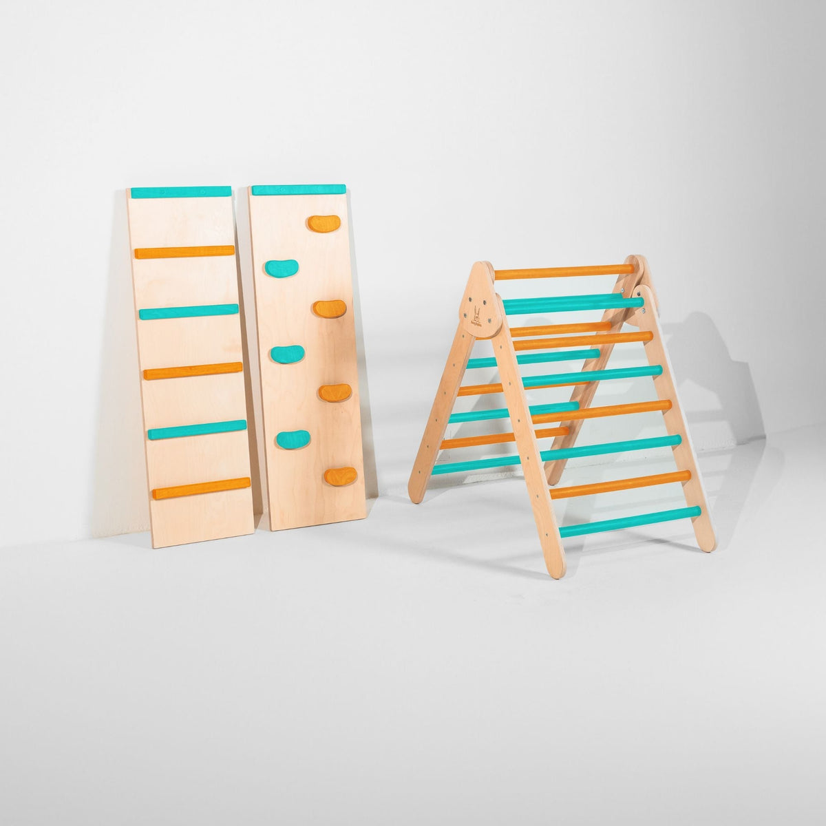 Classic Climber triangle with teal and orange rungs beside upright ladder and climbing-hold ramps.