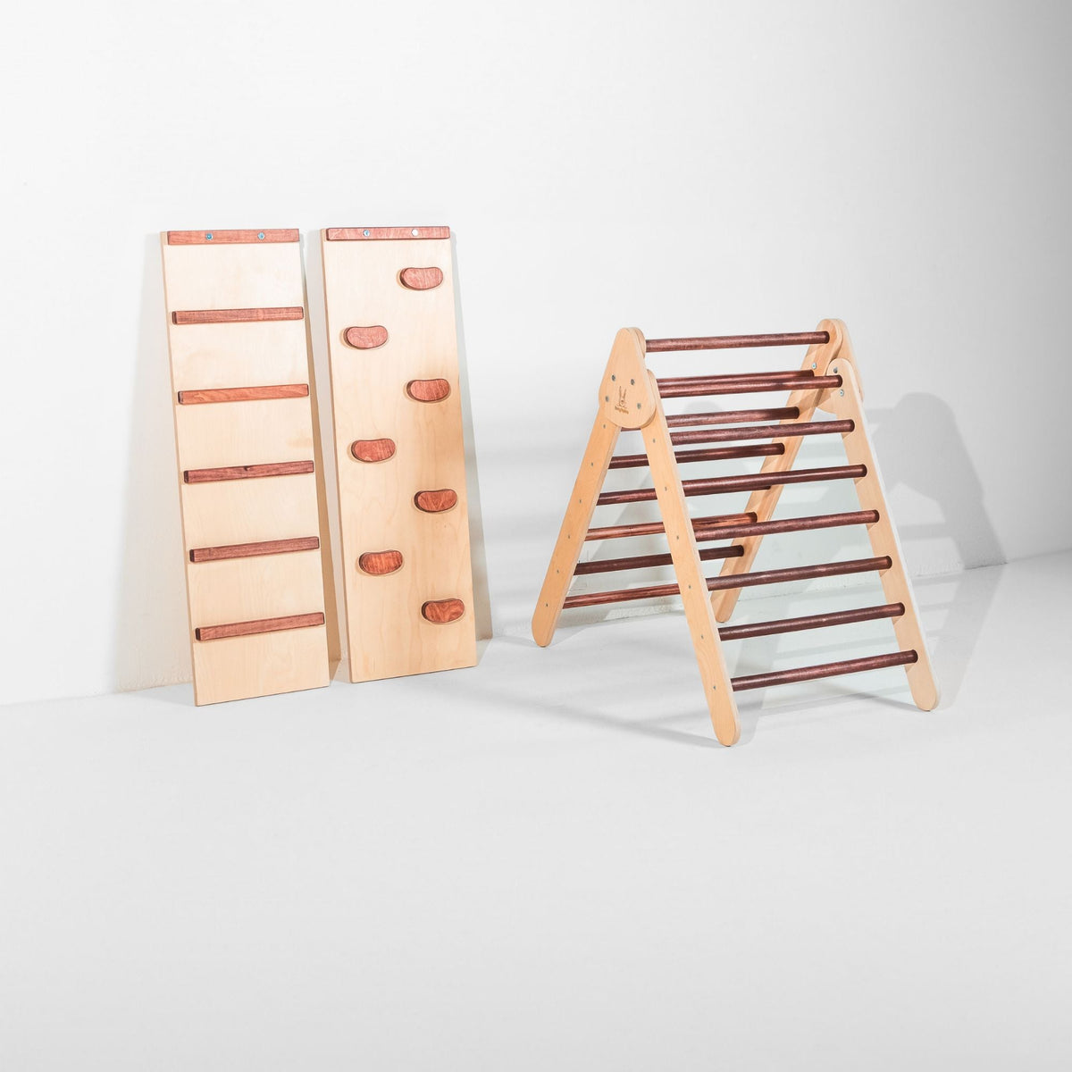 Classic Climber triangle with reddish-brown rungs beside upright ladder and climbing-hold ramps.