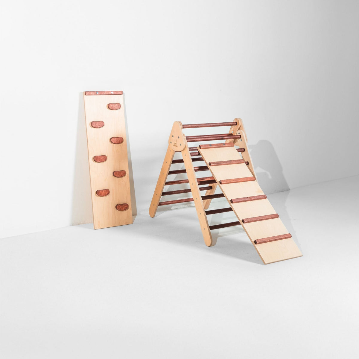 Reddish-brown triangle with attached ladder ramp and a climbing-hold ramp beside it.