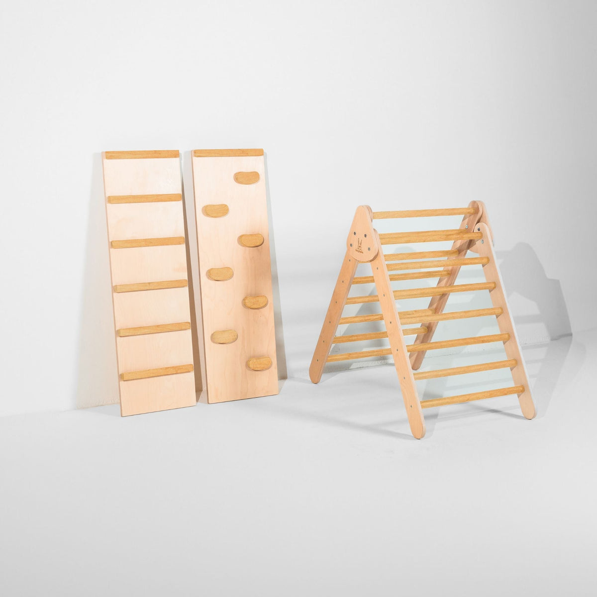 Classic Climber triangle with golden-tan rungs beside upright ladder and climbing-hold ramps.
