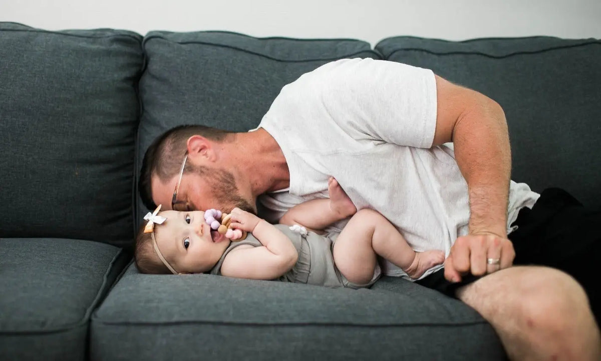 Lifestyle photo showing a wood and silicone teether with a child
