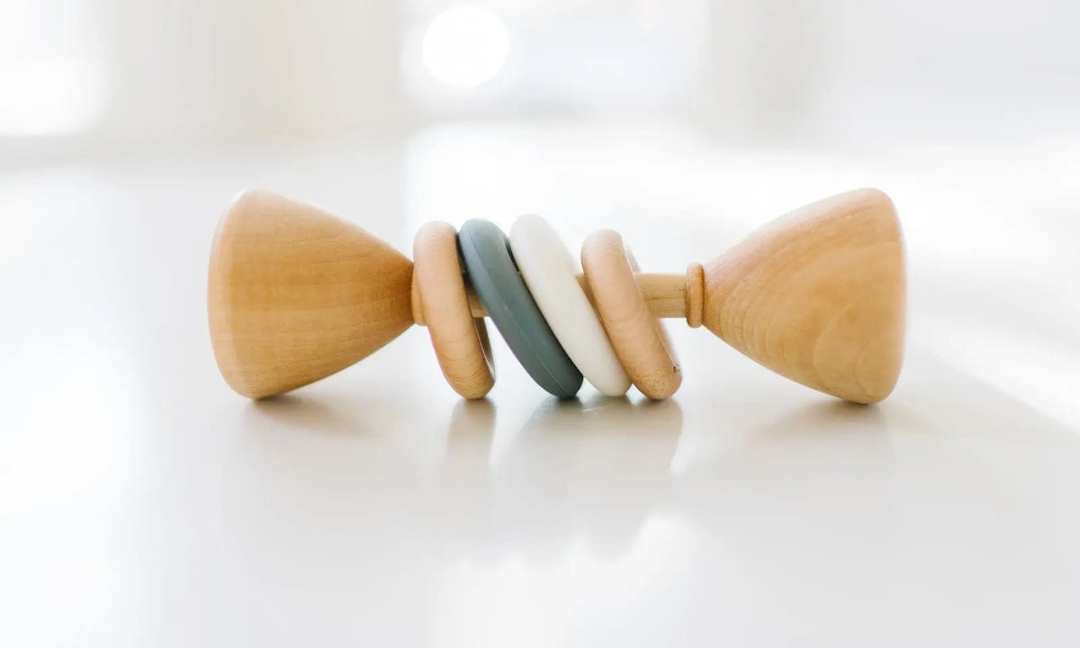 Bannor Toys Color Block Classic Baby Rattle, showing wooden body and colored silicone rings