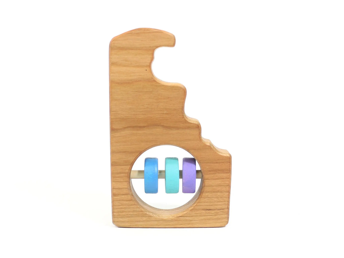 Bannor Toys Delaware State Wooden Baby Rattle, showing state-shaped cherry-wood body and colored rattle discs