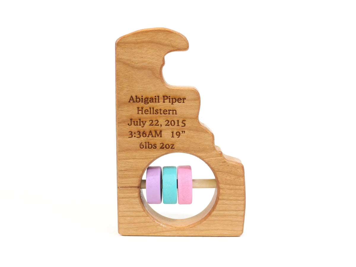 Bannor Toys Delaware State Wooden Baby Rattle with example laser engraving and colored rattle discs