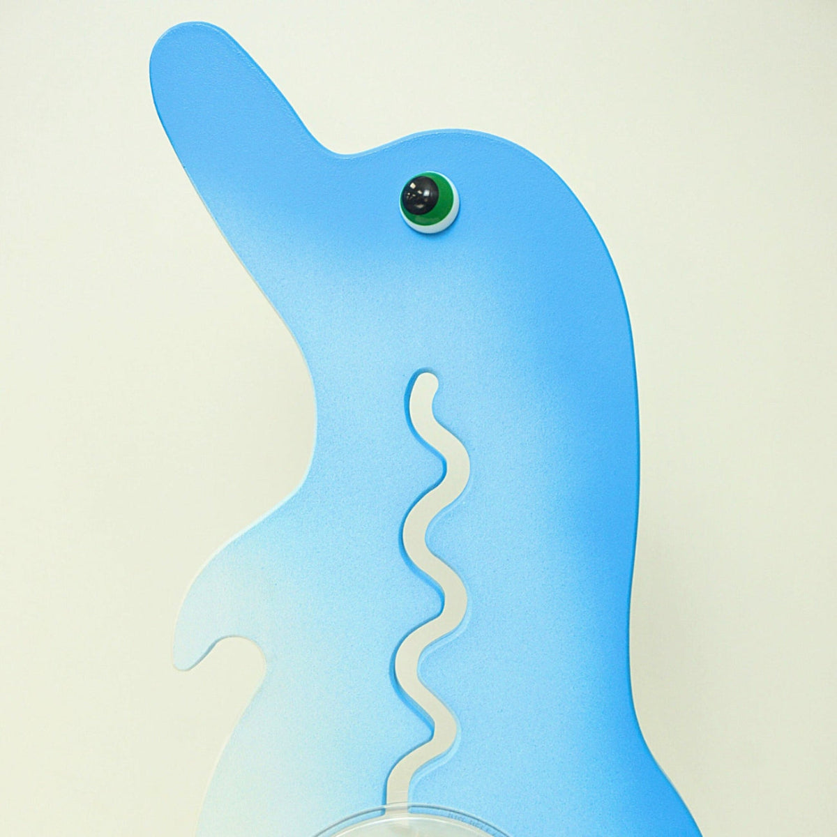 Reverse-side close-up of the blue and white dolphin coin bank