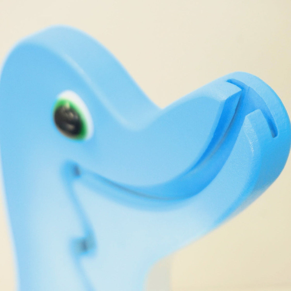 Side close-up of the dolphin mouth and coin-entry slot