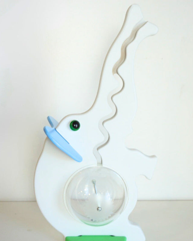 Front view of the gray elephant coin bank with blue ears