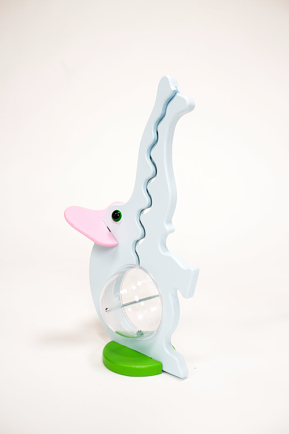 Angled view of the pink-eared elephant bank with raised trunk coin track