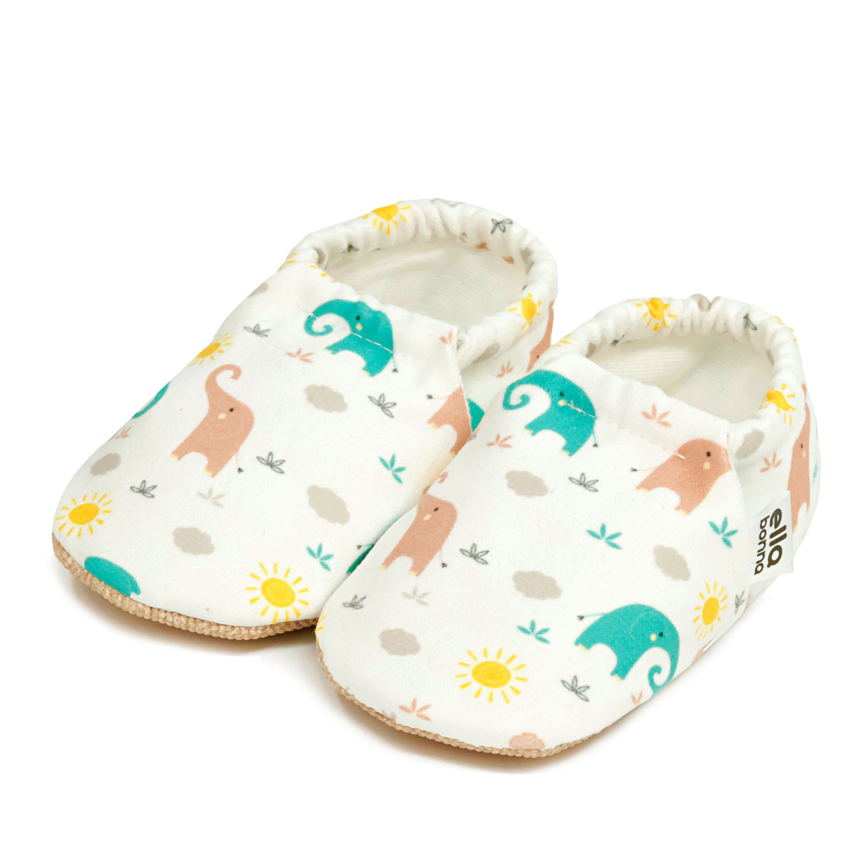 Pair of cream slip-on baby moccasins with pastel elephant print on a white background.