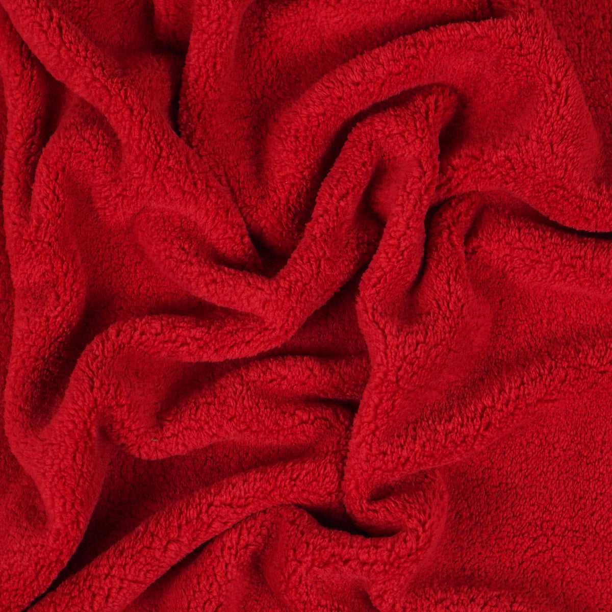 Red fleece blanket gathered to show texture.