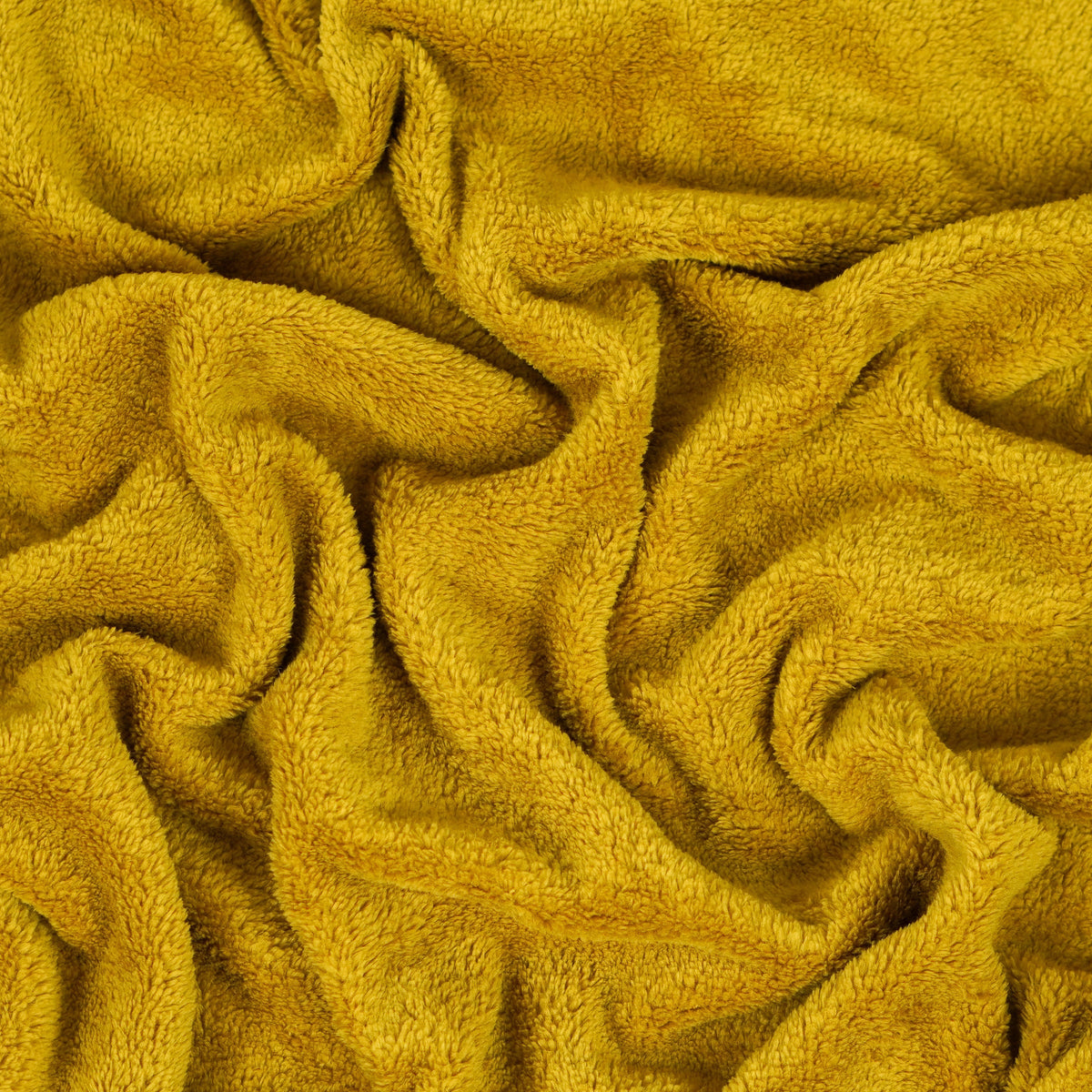 Mustard yellow fleece blanket gathered to show texture.