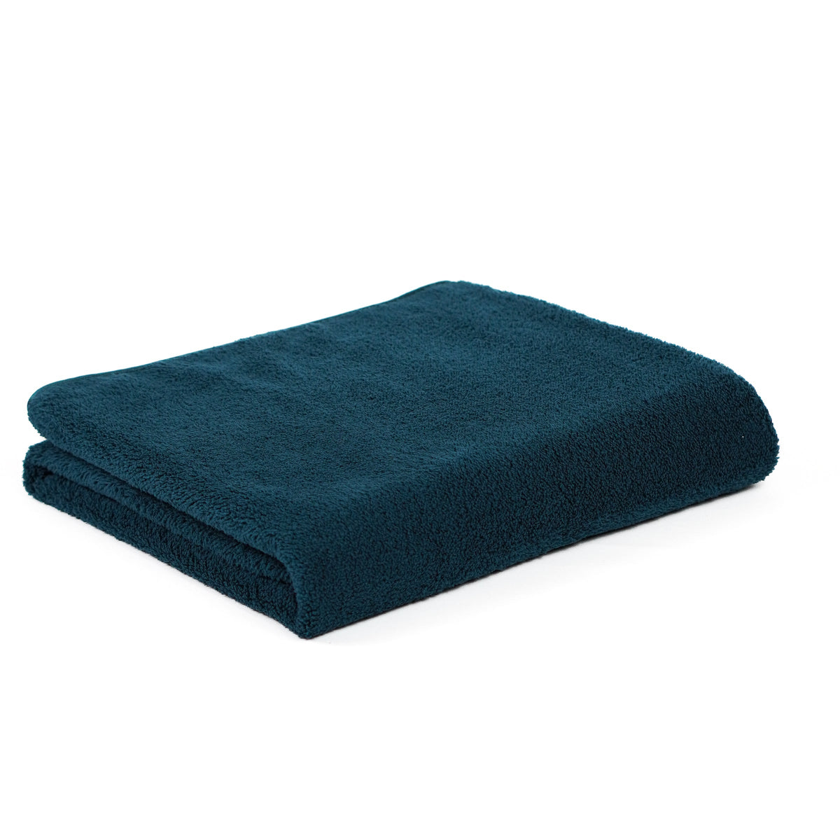 Teal fleece blanket folded on white.