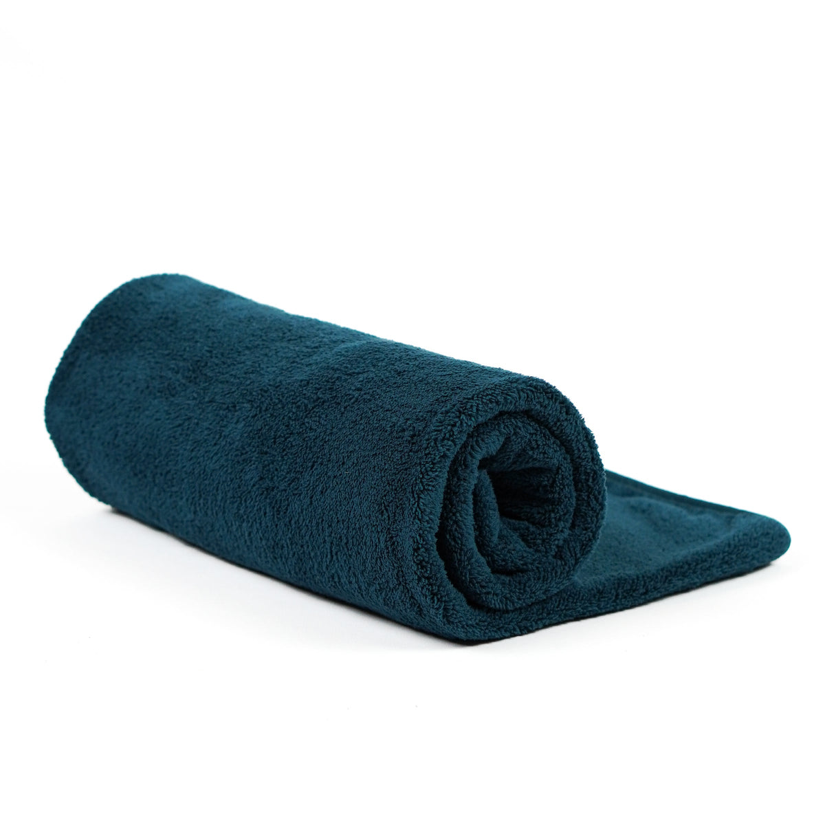 Teal fleece blanket rolled on white.