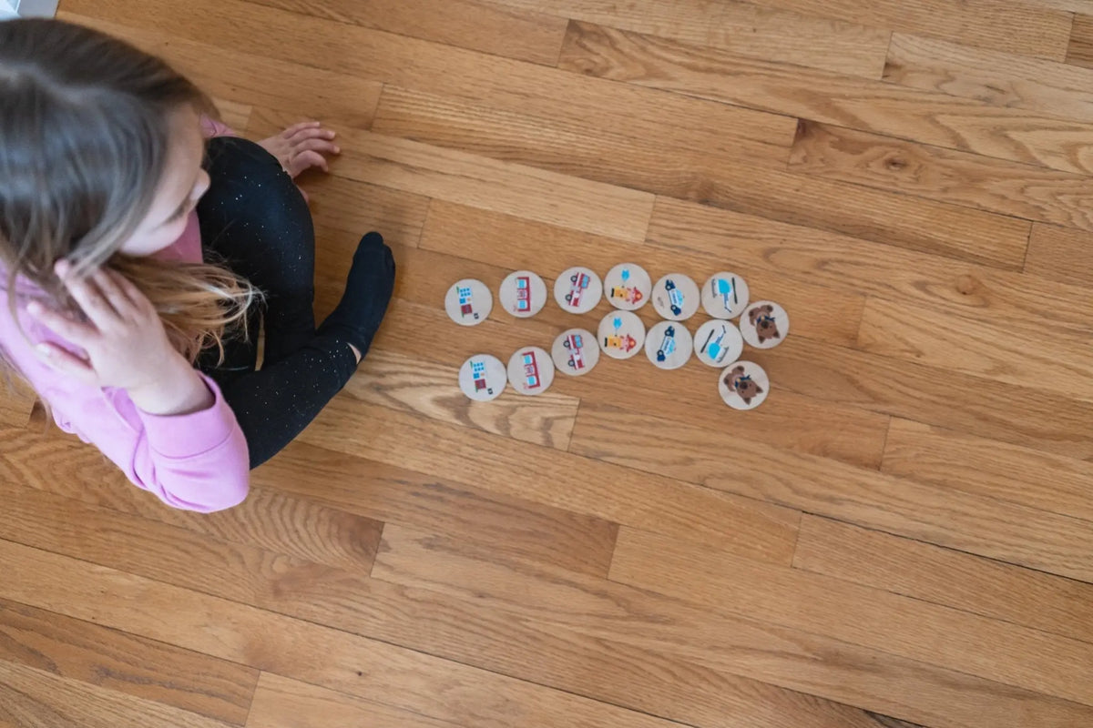 Lifestyle photo showing first responder matching tiles with a child