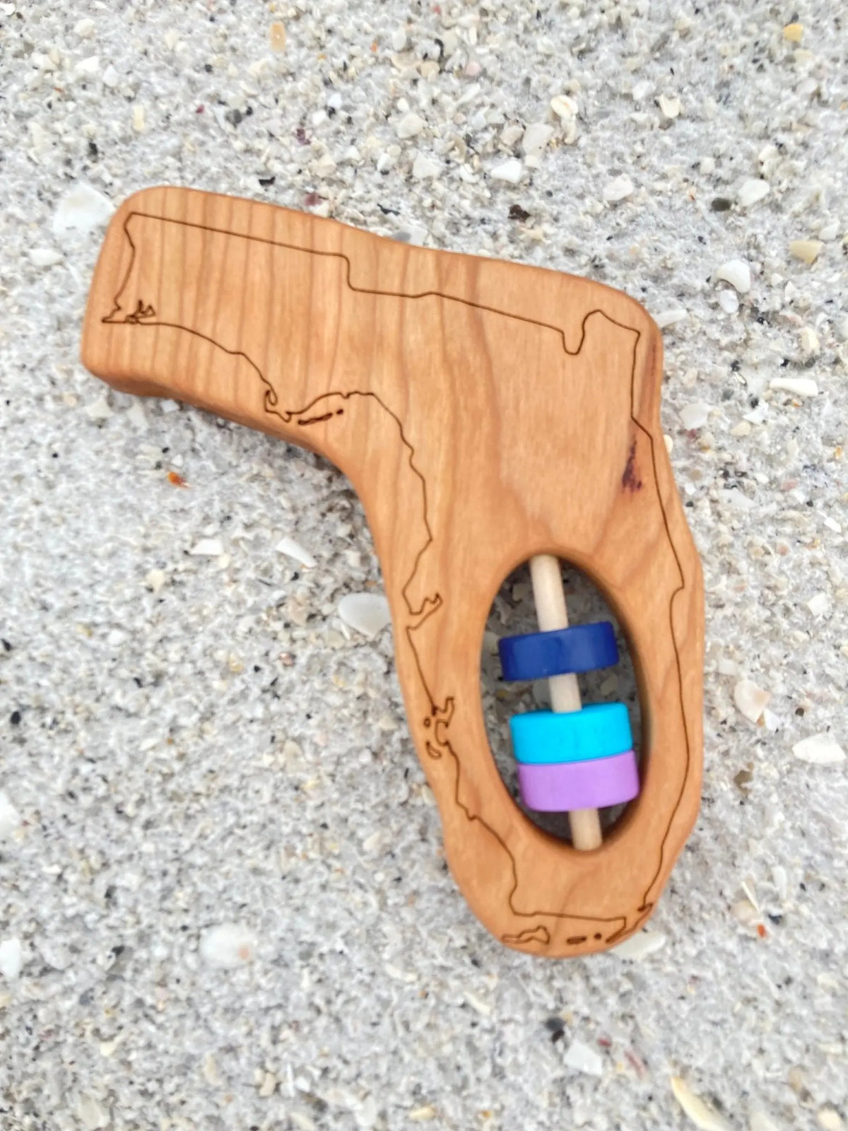 Bannor Toys Florida State Wooden Baby Rattle with example laser engraving and colored rattle discs