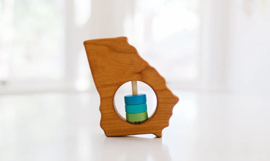 Bannor Toys Georgia State Wooden Baby Rattle, showing state-shaped cherry-wood body and colored rattle discs