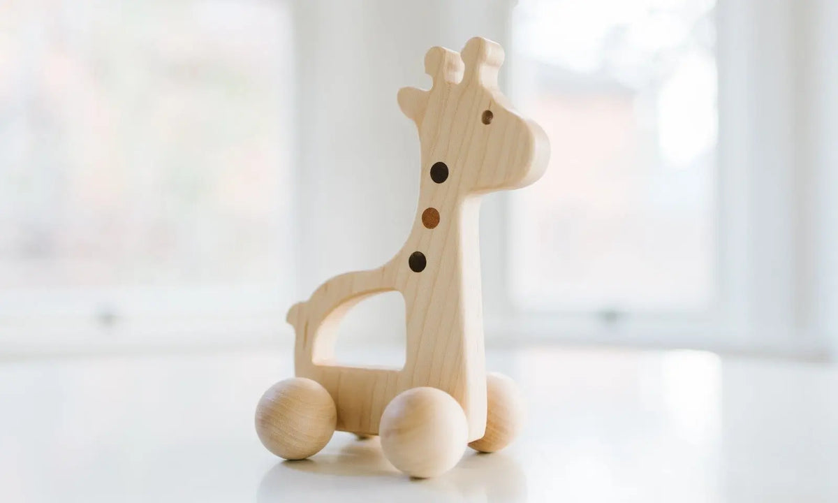 Bannor Toys Giraffe Push Toy, showing animal-shaped wooden body and rolling wheels