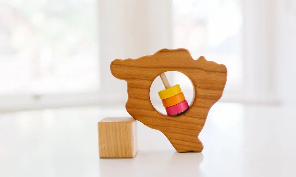 Bannor Toys Hawaii State Big Island Wooden Baby Rattle, showing state-shaped cherry-wood body and colored rattle discs
