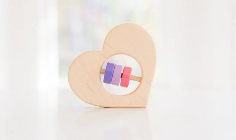 Bannor Toys Heart Baby Rattle, showing wooden shape and movable rattle pieces