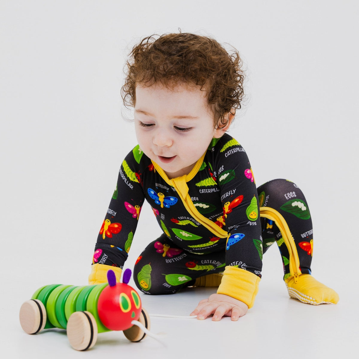 Baby reaching toward a toy while wearing Bam & Stitch It's Morphing Time! Convertible Romper.