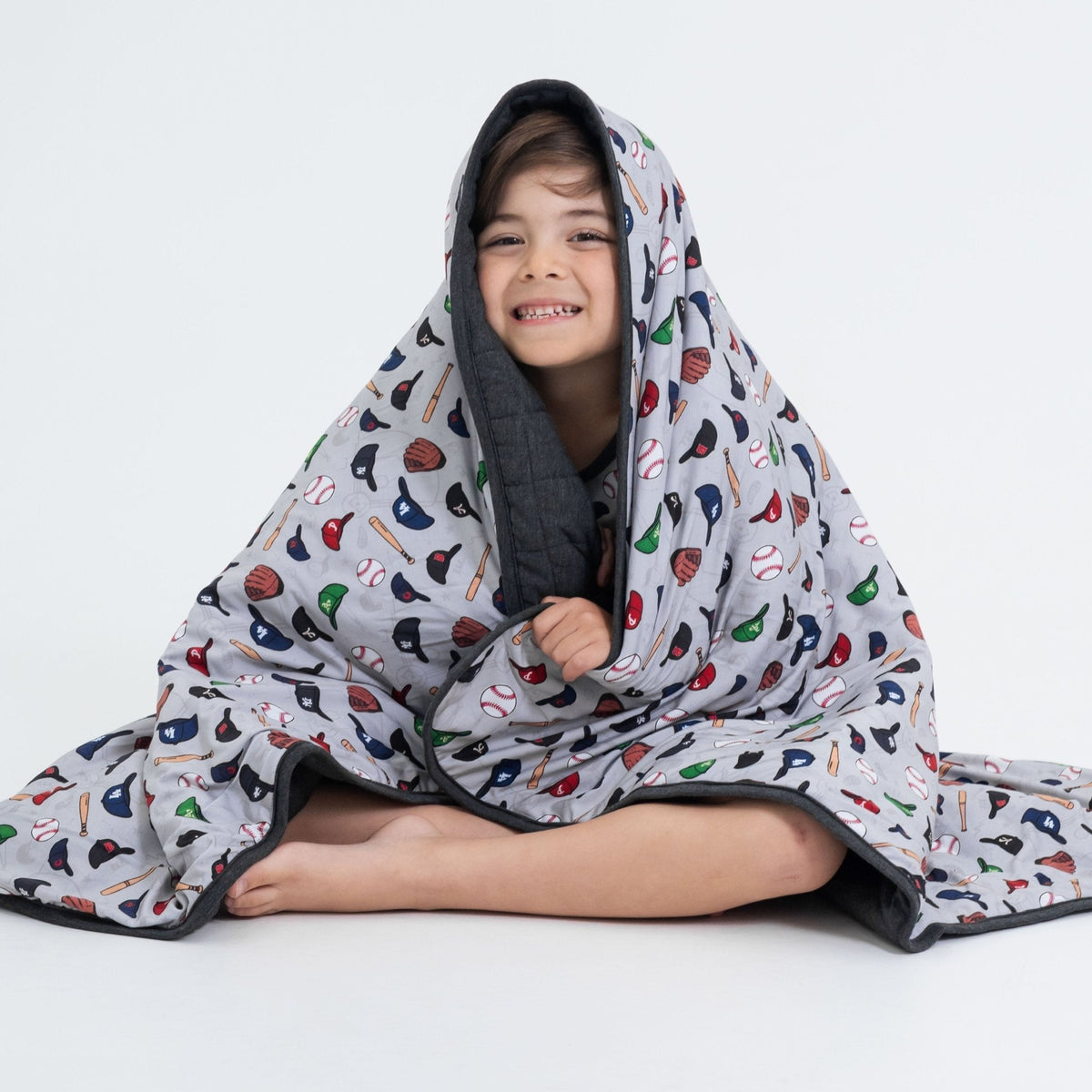 Seated child with Bam & Stitch Major League Buddies Blanket draped over their head.