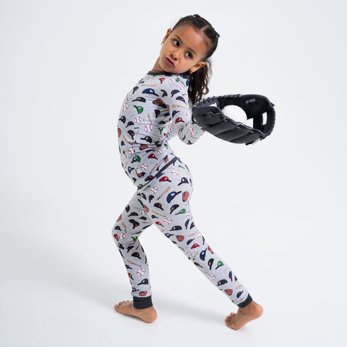 Child holding a baseball glove while wearing Bam & Stitch Major League Buddies Long Sleeve Pajamas.