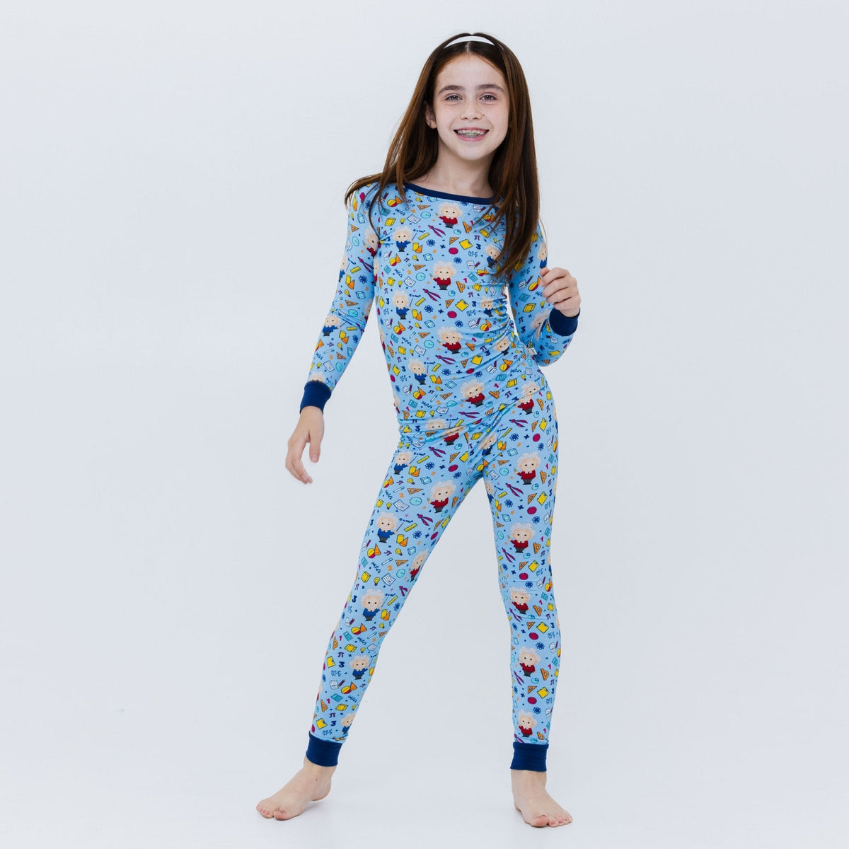 Full-length view of a child standing in Bam & Stitch Mathematical Marvel Long Sleeve Pajamas.