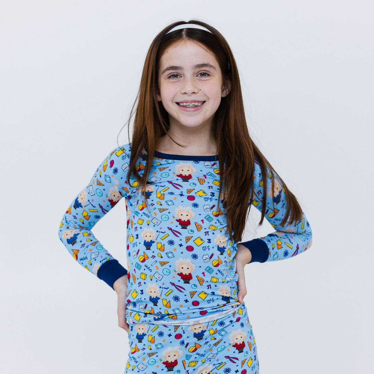 Child posing with both hands on their hips in Bam & Stitch Mathematical Marvel Long Sleeve Pajamas.