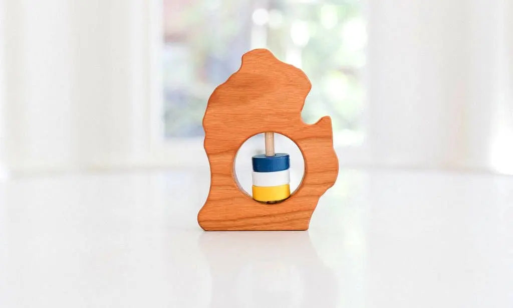Bannor Toys Michigan (Lower Peninsula) Wooden Baby Rattle, showing state-shaped cherry-wood body and colored rattle discs