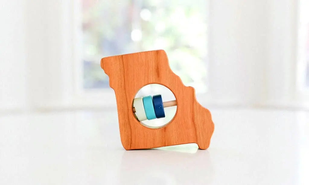 Bannor Toys Missouri State Wooden Baby Rattle, showing state-shaped cherry-wood body and colored rattle discs